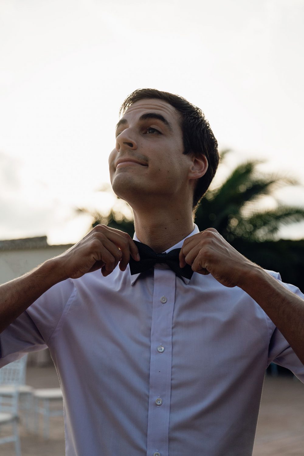 funny portrait of a wedding guest with a bow tie
