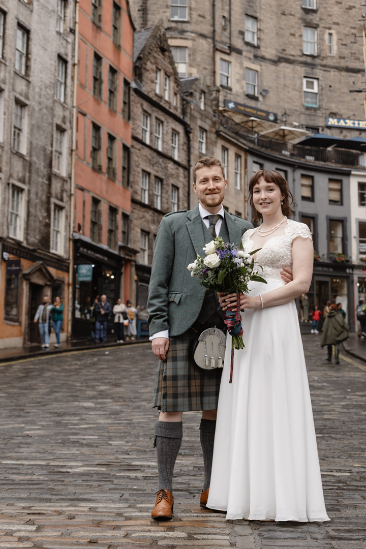 Newly wed couple at the colourful victoria street in Edinburgh